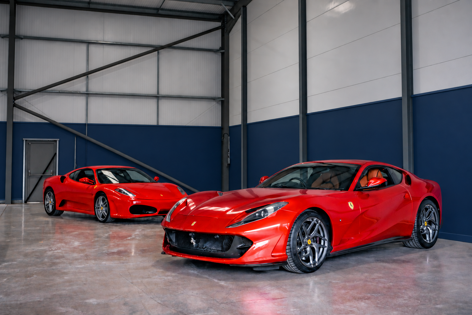 Two red Ferraris waiting inside the Mallards showroom