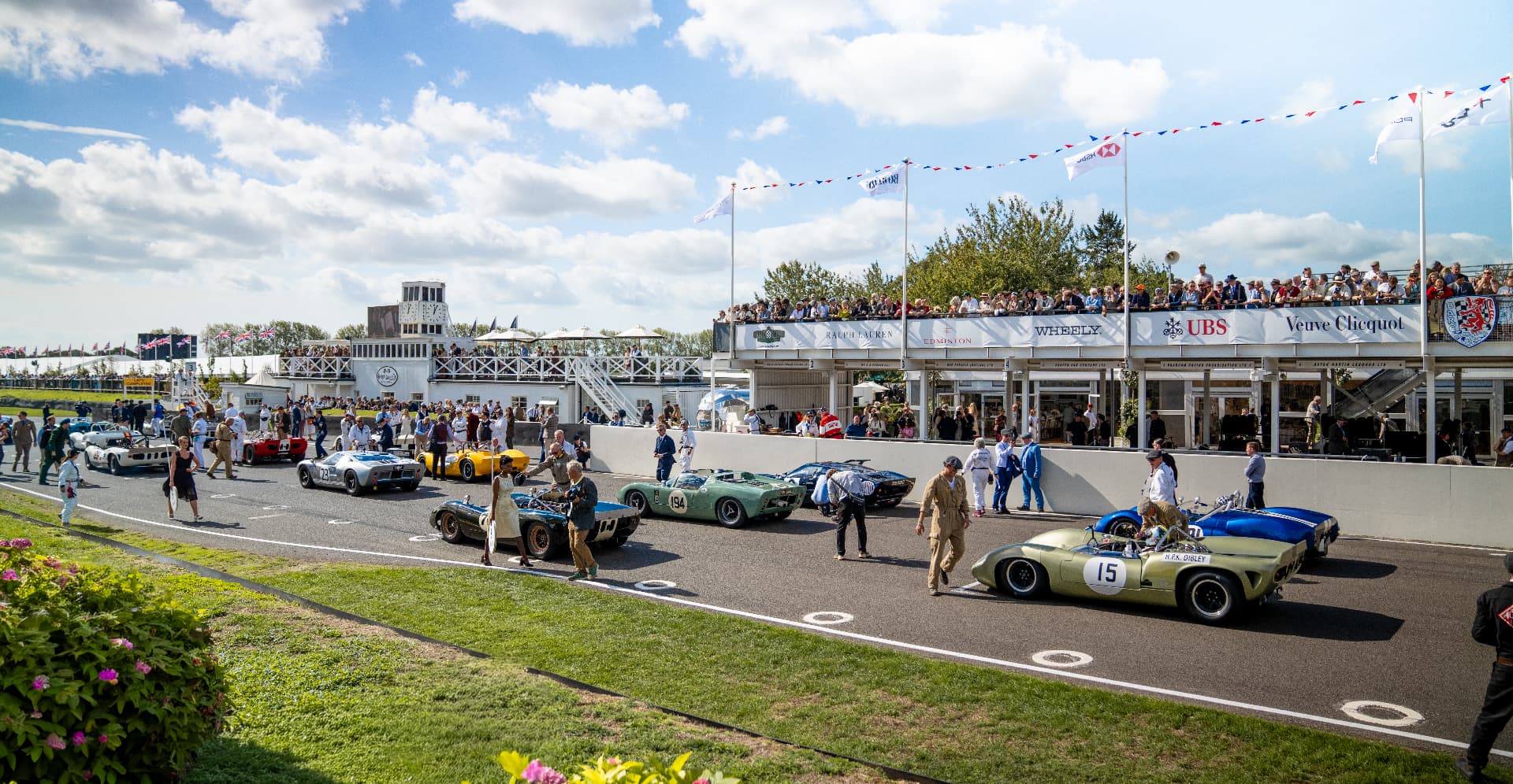 Classic racing cars lined up on the grid at Goodwood Revival
